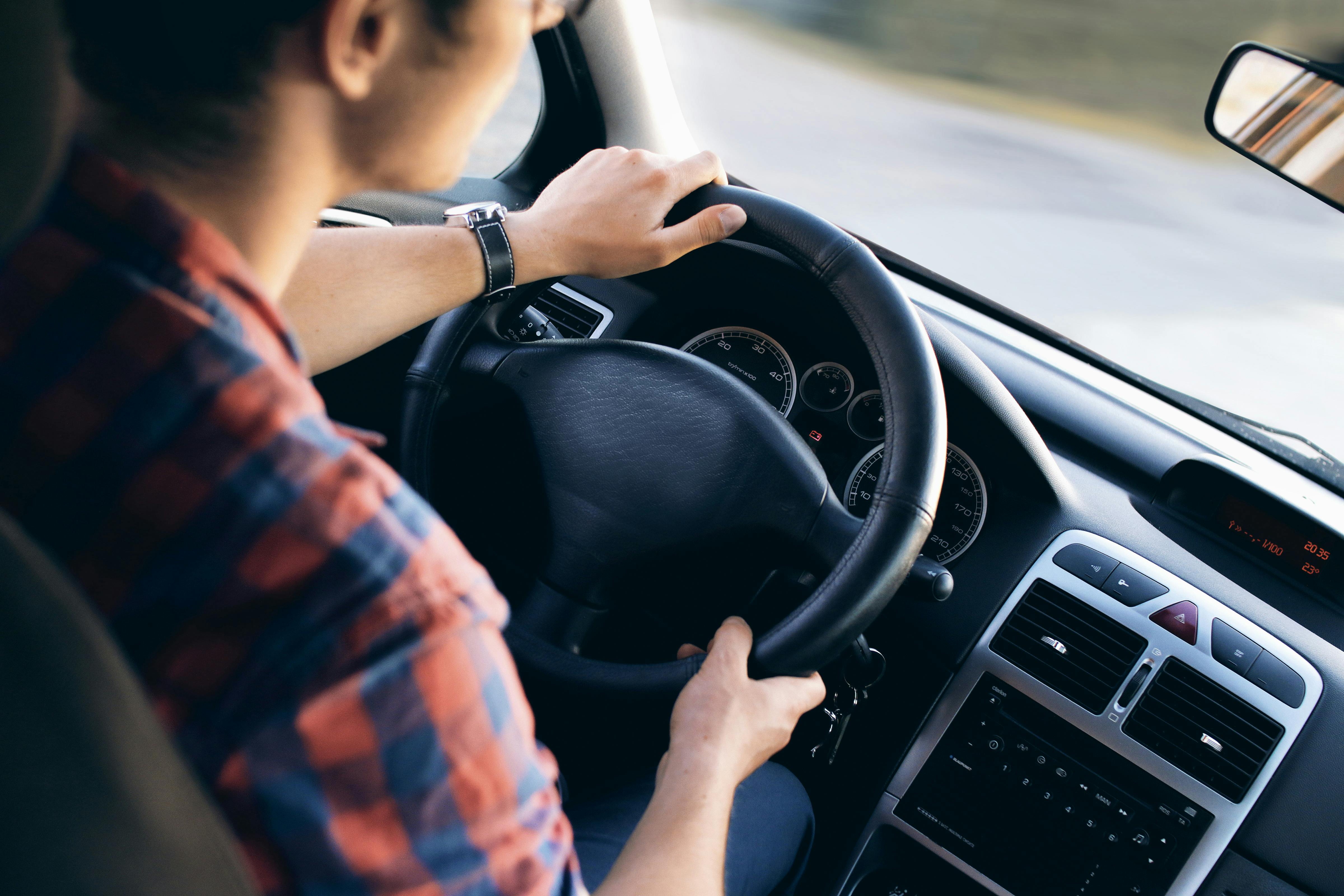 Driver steering a car